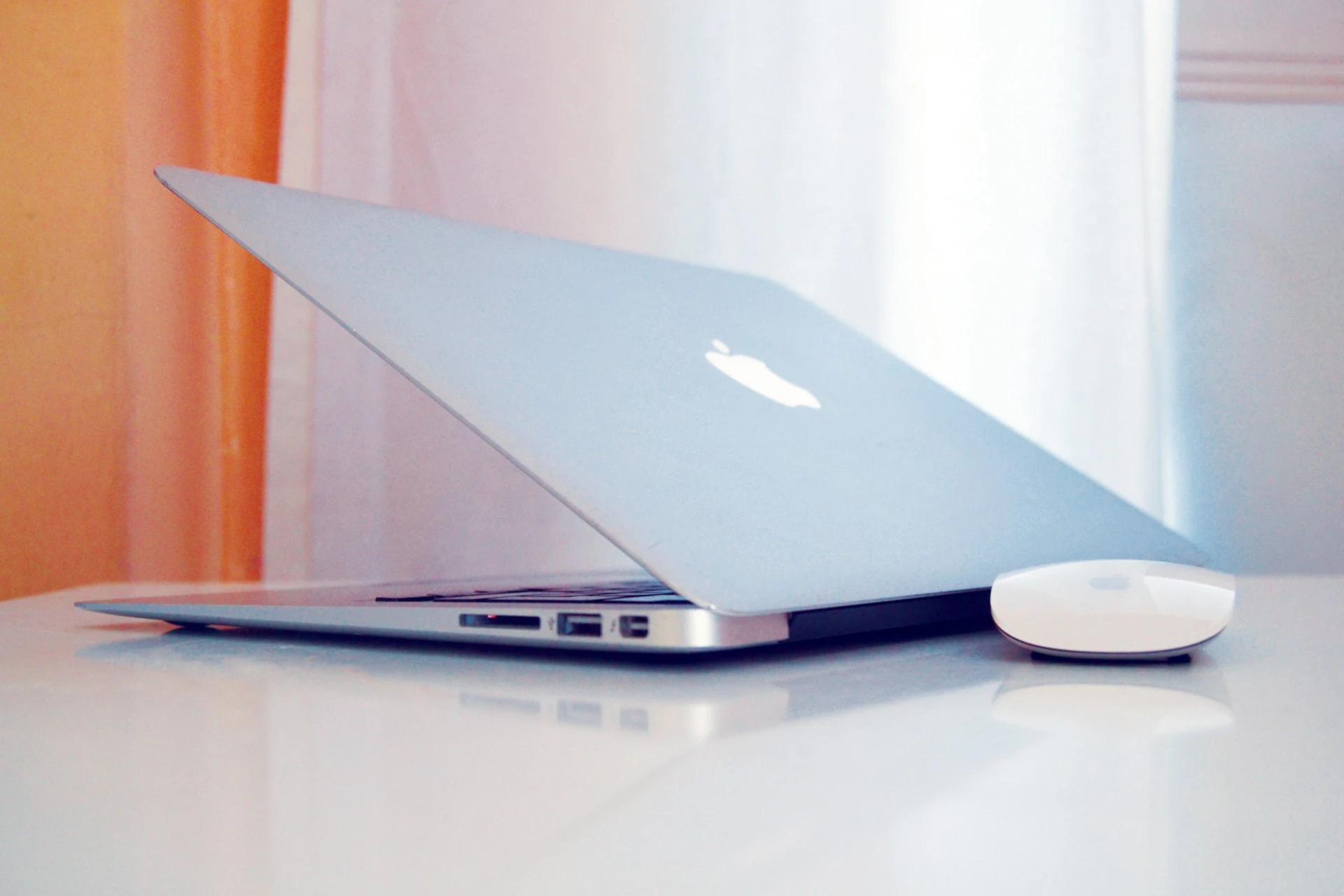 MacBook on a desk in soft window light